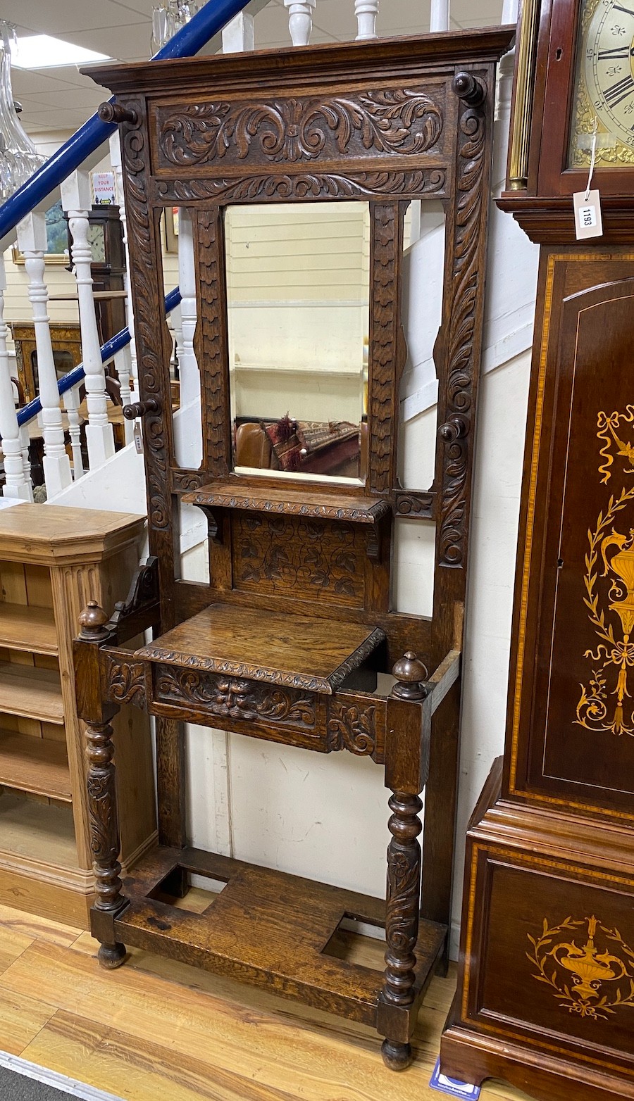 A late Victorian carved oak hall stand, width 78cm, depth 32cm, height 196cm